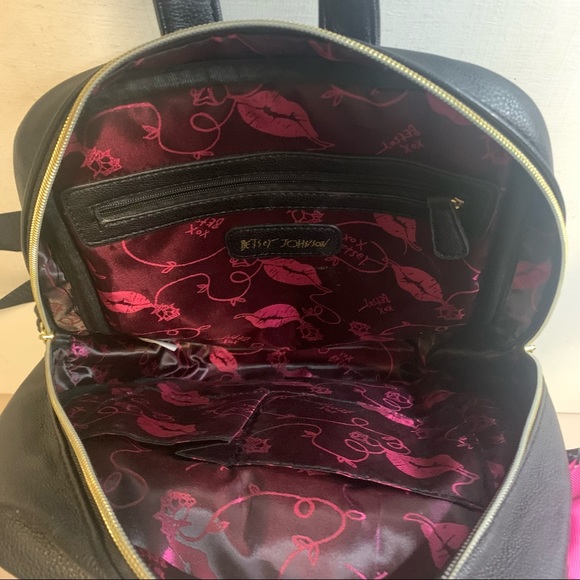 black leather backpack with pink white and burgundy stripes Betsey Johnson Black & White Faux Leather Striped Backpack